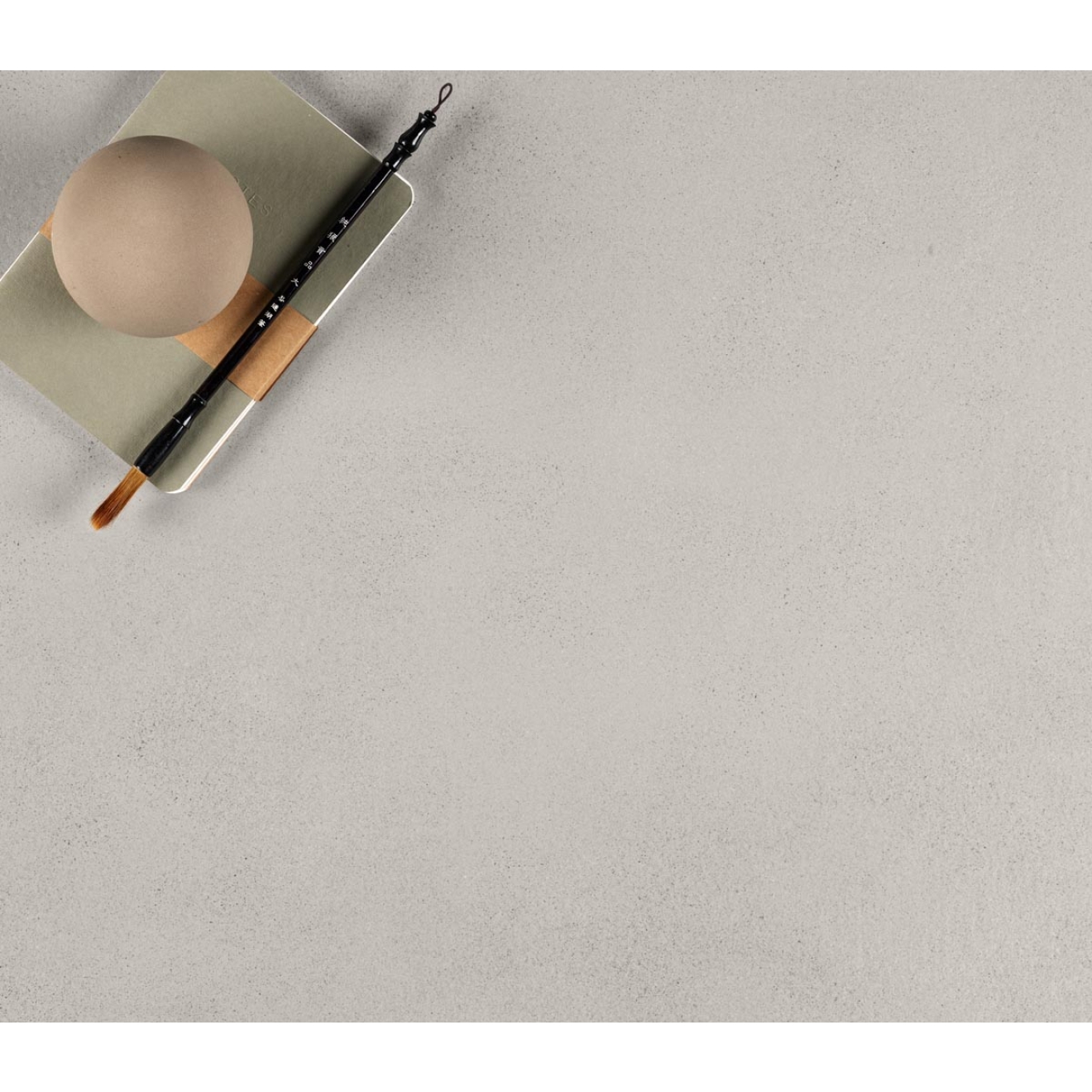 Fliese Sant Agostino Sable in der Farbe Pearl verlegt unter einem Notizblock