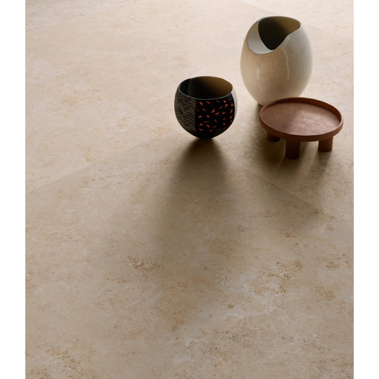 Fliese Sant Agostino Unionstone in der Farbe Jura Stone verlegt unter zwei Vasen