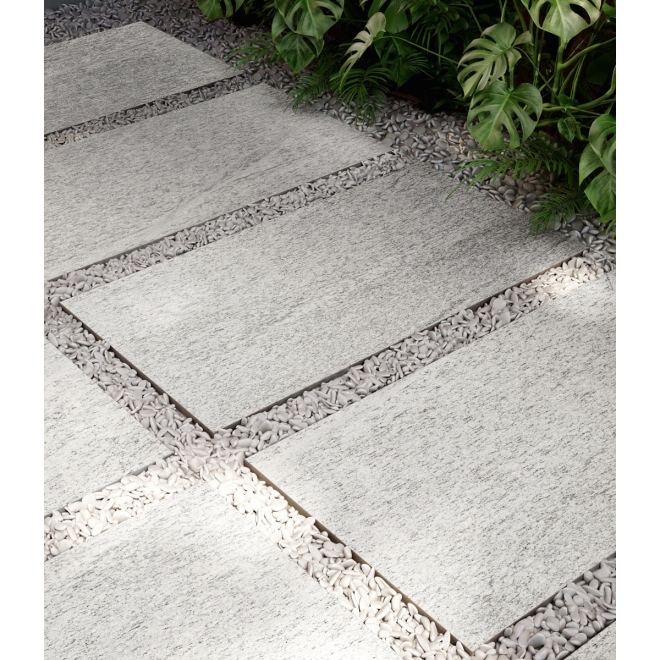 Fliese Sant Agostino Unionstone in der Farbe Duke White verlegt in einem Kiesbett