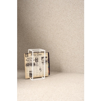 Fliese Sant Agostino Newdeco in der Farbe Sand verlegt hinter einem Quader mit einer Zeitung drin