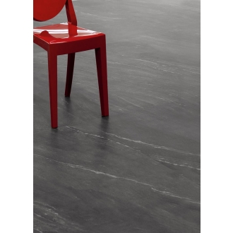 Fliese Sant Agostino Waystone in der Farbe Dark verlegt unter einem roten Stuhl